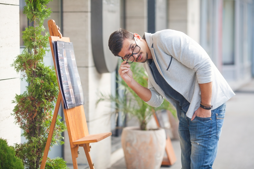Young Man Reading Menu