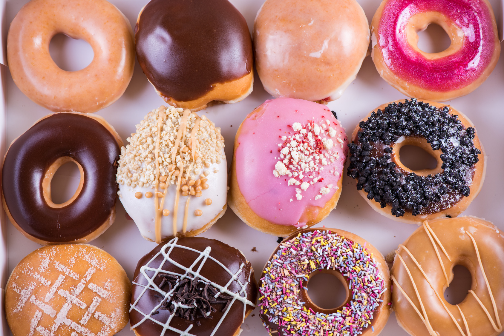 Dozen of vibrant artisan donust from above