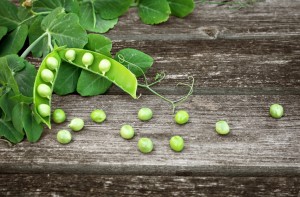 Peas on wooden board