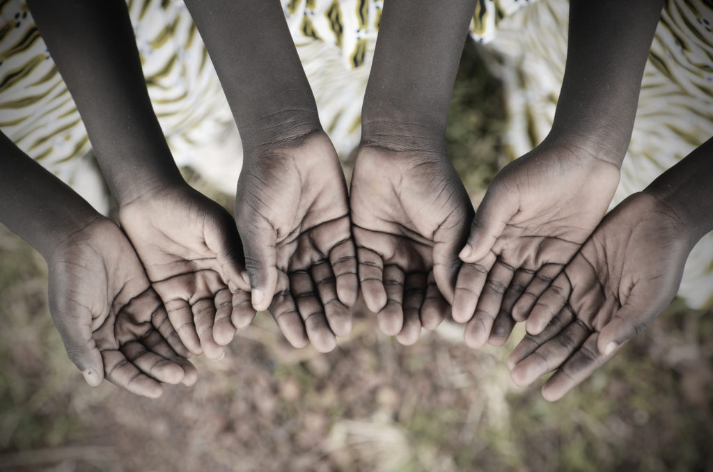 African Children Holding Hands Cupped To Beg Help. Poor African children keeping their cupped hands, asking for help. African children suffer from poverty, diseases, water scarcity and malnutrition.