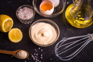 Mayonnaise on a dark background. Ingredients mayonnaise