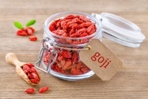 organic goji berries in a glass jar on wooden background bacche di goji