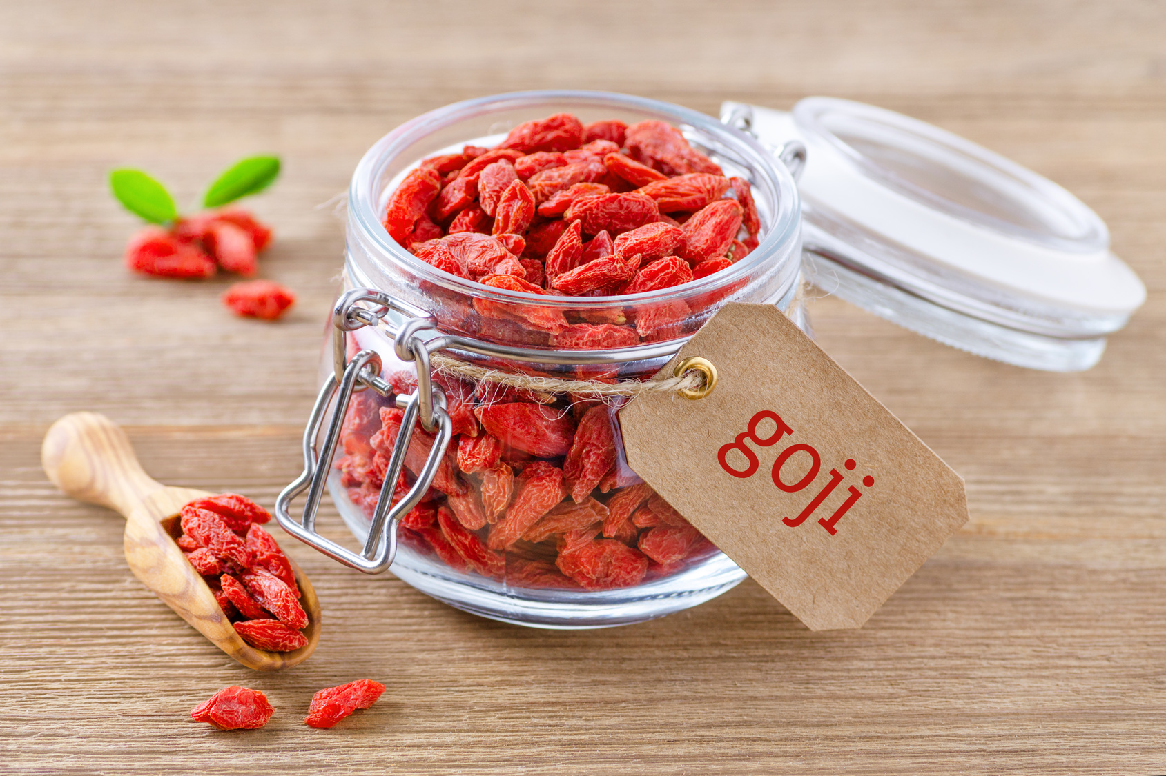 organic goji berries in a glass jar on wooden background bacche di goji