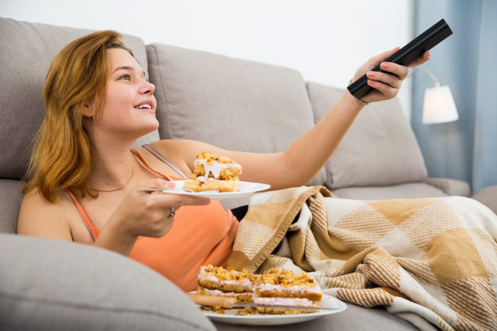 Smiling female eating sweet cake