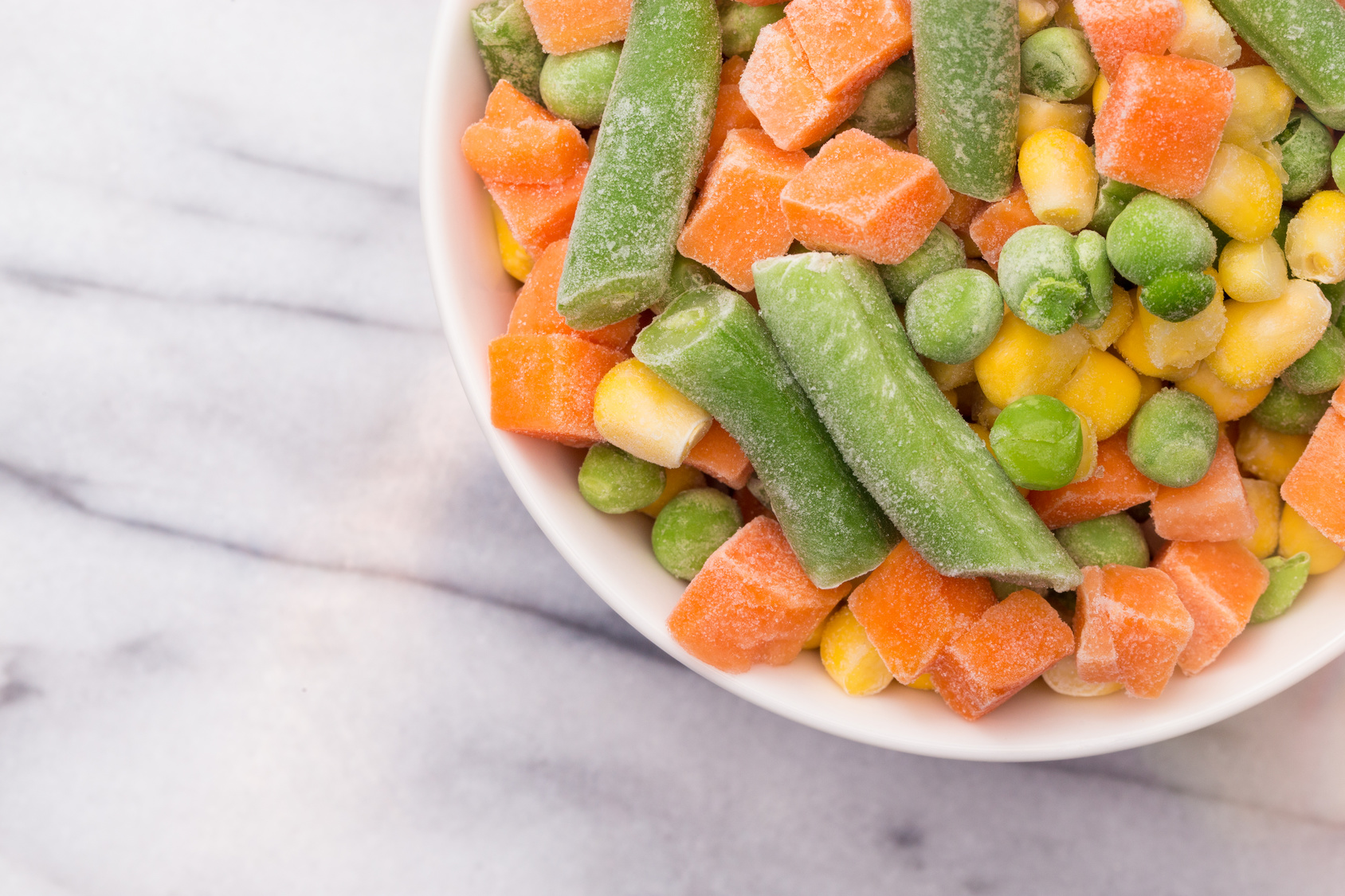 Mixed Vegetables Isolated on a White Marble Background