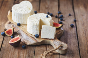 ricotta cheese on rustic cutting board over wooden table