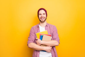 Ragazzo con quaderni e libri in mano; concept: università, master