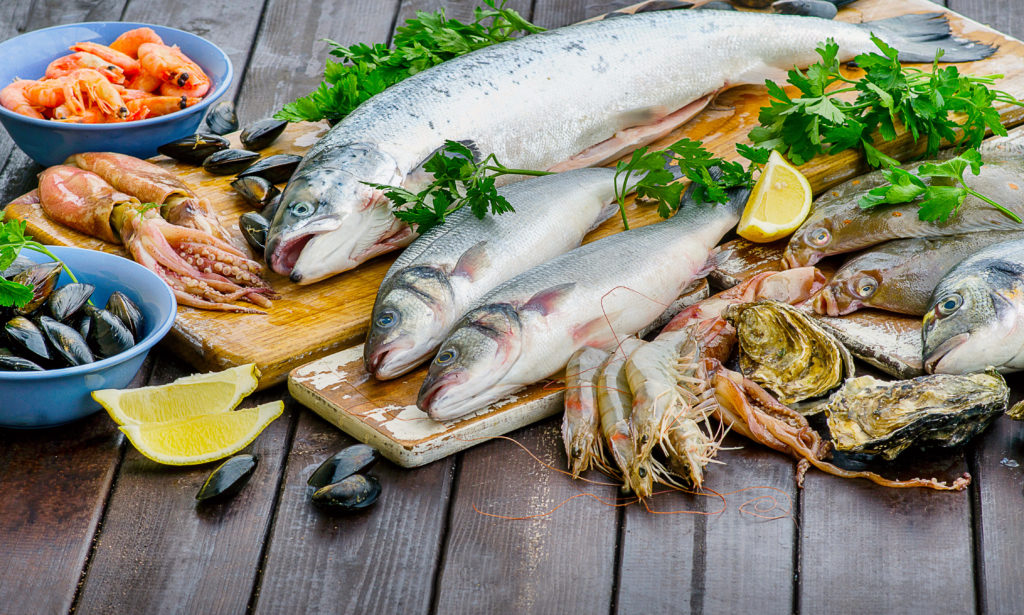 Raw seafood on a wooden board.