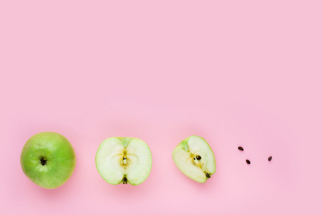 Green apple, half apple and quarter apple