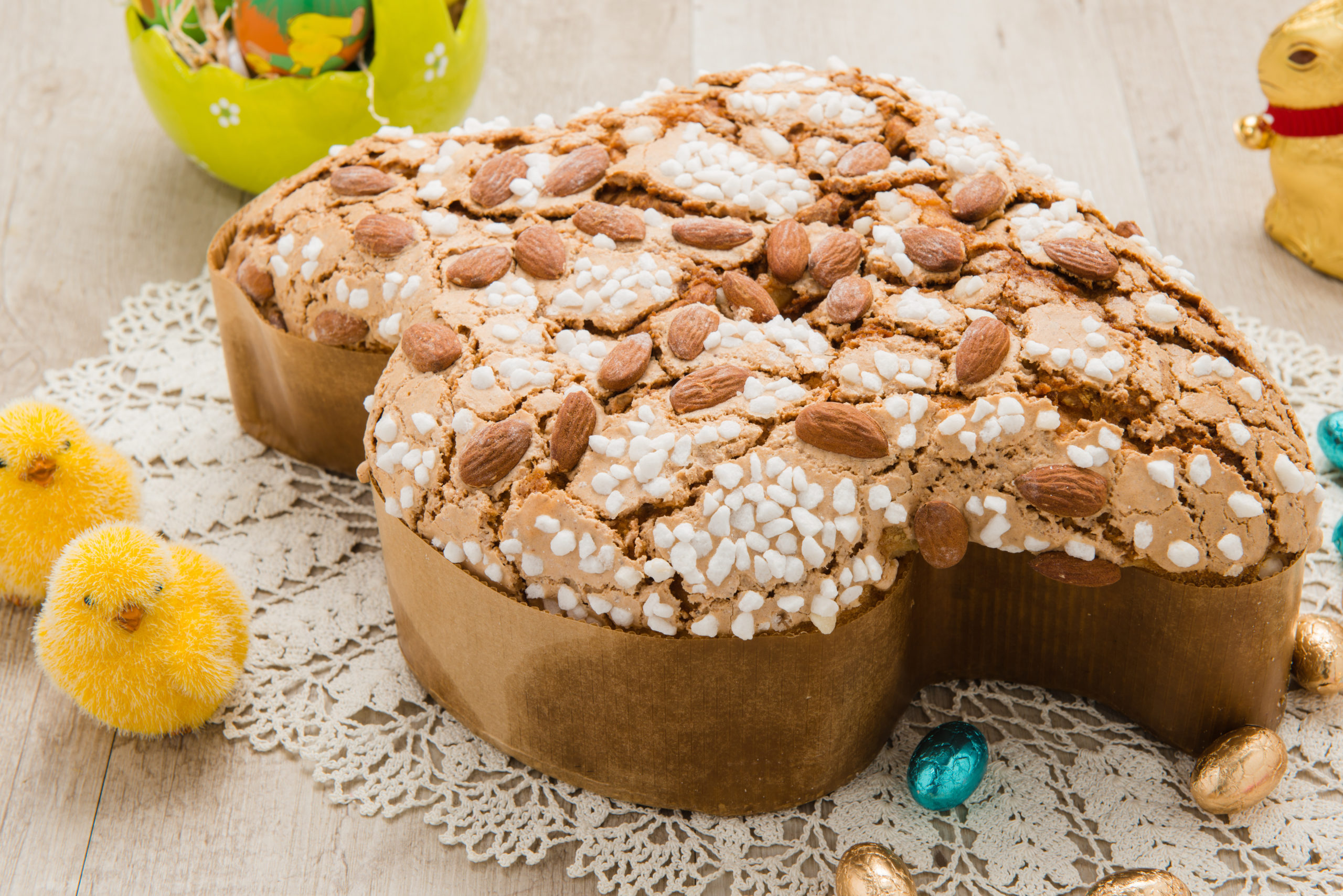 Colomba pasquale su un centrino circondata da decorazioni di Pasqua