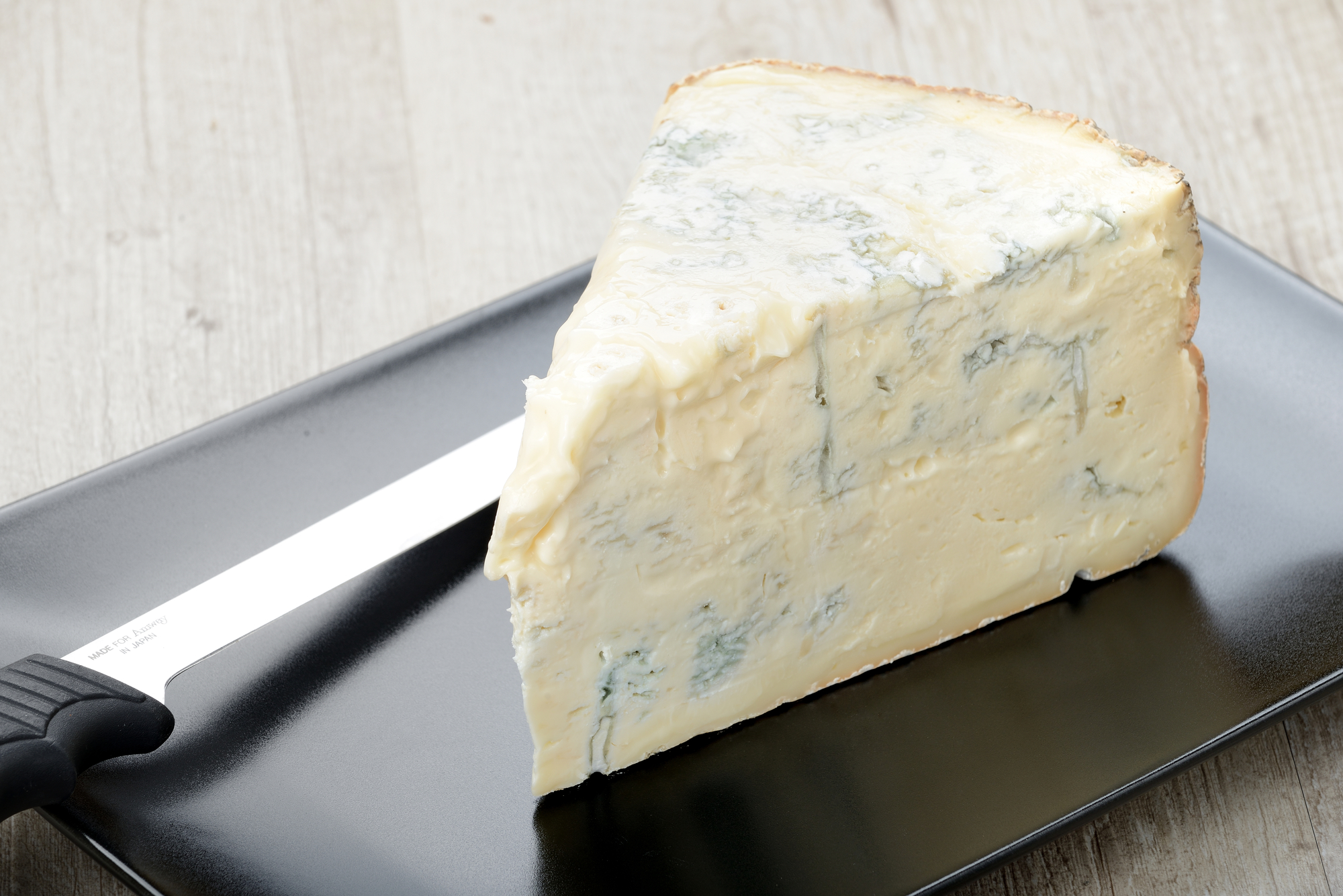 Fetta di gorgonzola con accanto un coltello