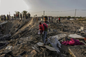 Archive******* (INT) International Criminal Court for Israel. April 10, 2021 Gaza, Palestine: A Palestinian child carries his clothes over the rubble of a house destroyed in an Israeli air strike in the southern Gaza Strip. Israel said on Thursday, April 8, 2021 that it would formally reject the International Criminal Court's decision to open an investigation into possible war crimes against the Palestinians. The court is expected to look into possible war crimes committed by Israeli forces and Palestinian militants during and after the 2014 Gaza war, as well as Israeli settlements in the West Bank and East Jerusalem. Picture taken on 13, 2019. Credit: Yousef Masoud/Thenews2.